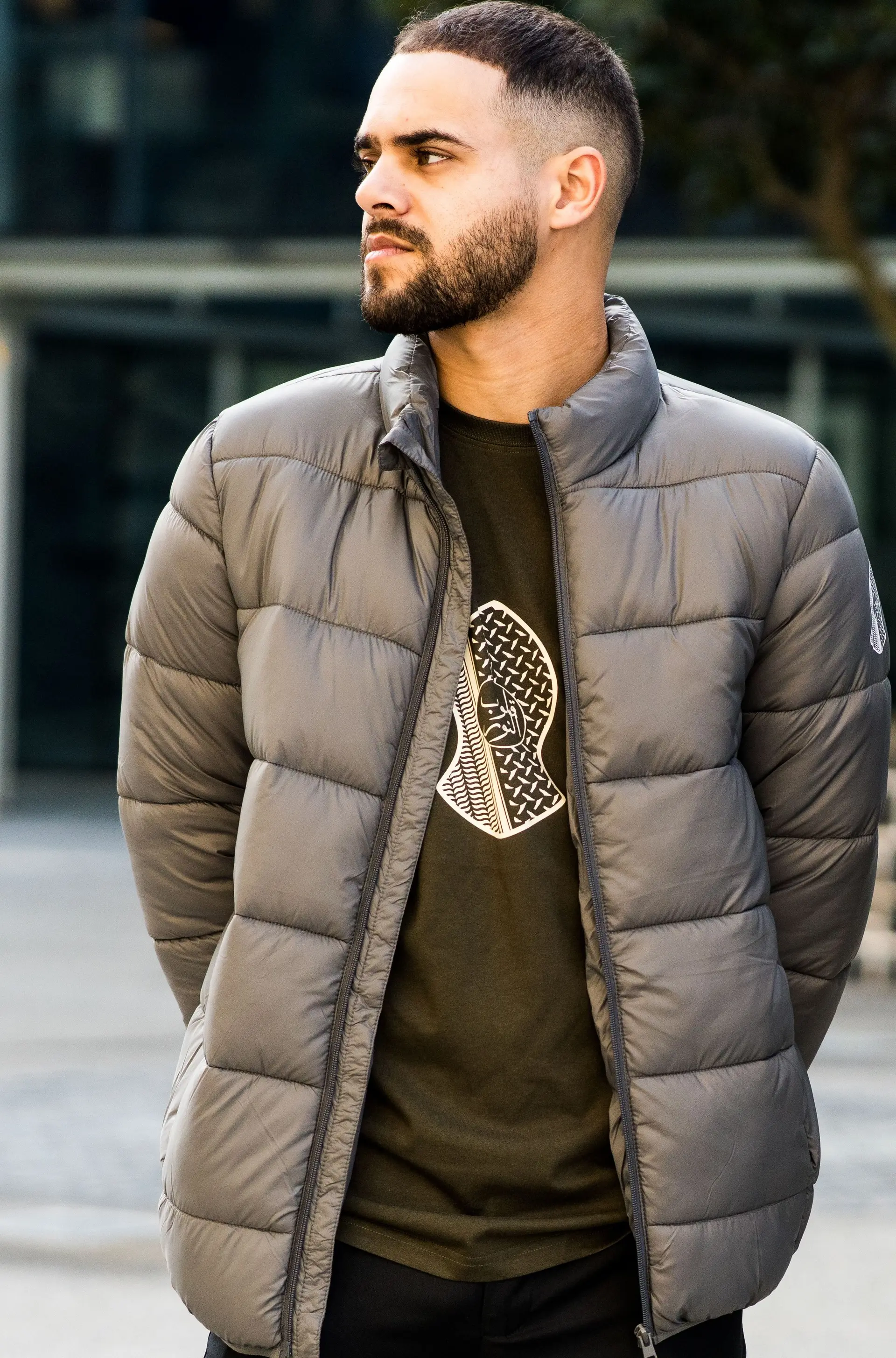 Olive t-shirt worn under an open grey puffer